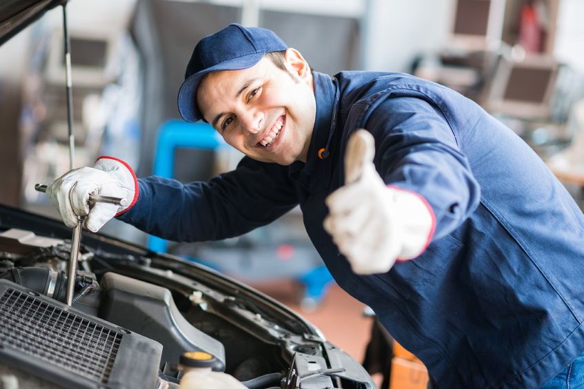 41808619 - portrait of an auto mechanic at work on a car in his garage